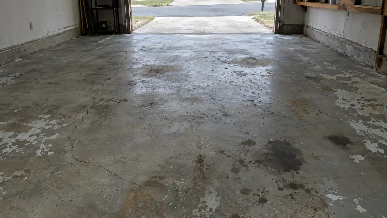 Before: a cracked, oil-stained, peeling concrete garage floor