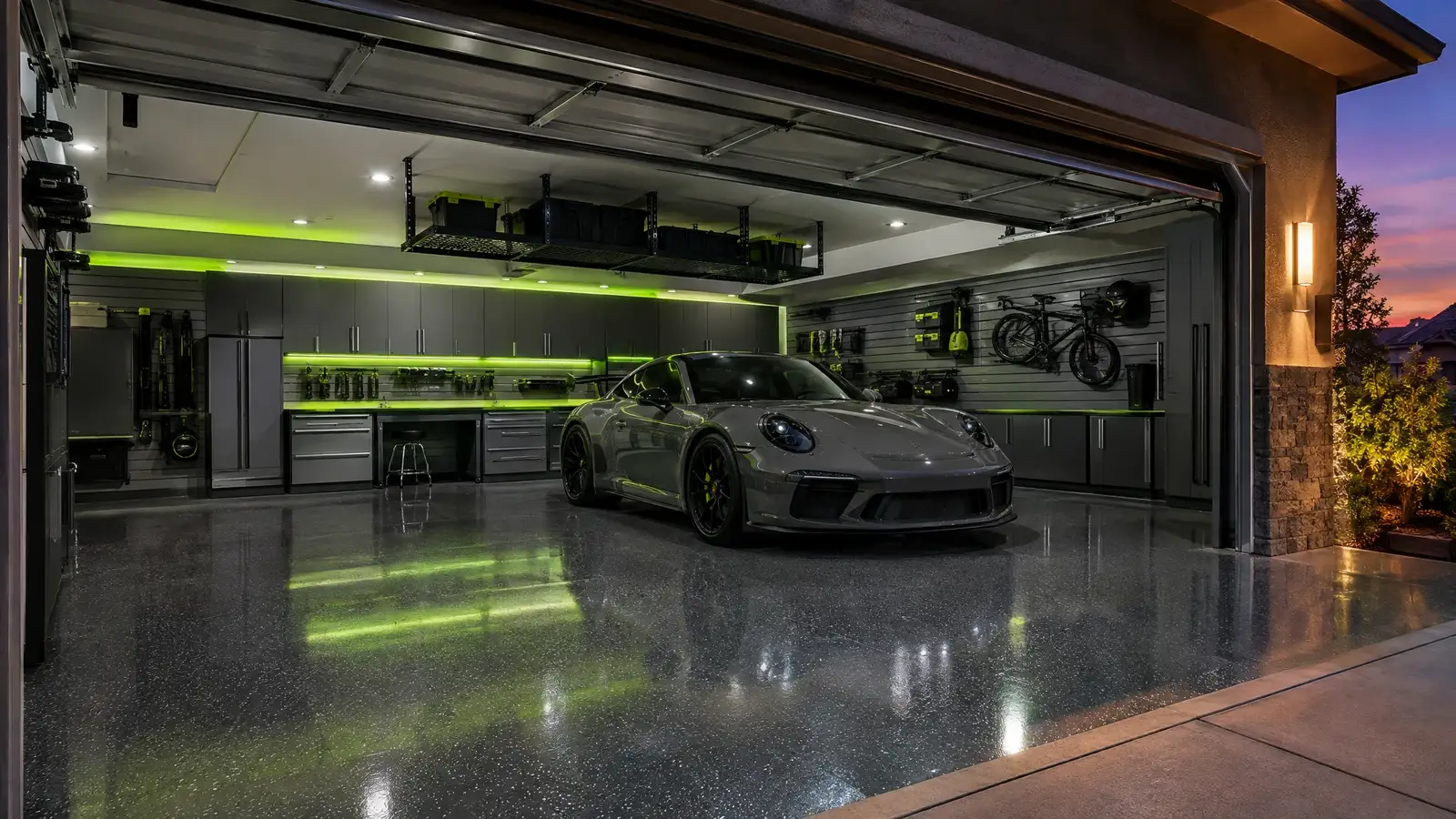 A finished custom garage with cabinets, slatwall and a glossy floor